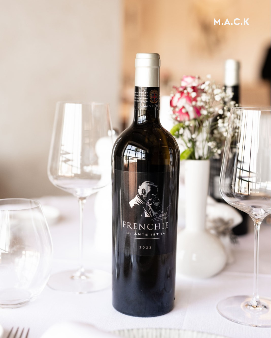 Saints Hills winery — a Frenchie bottle on a tasting table